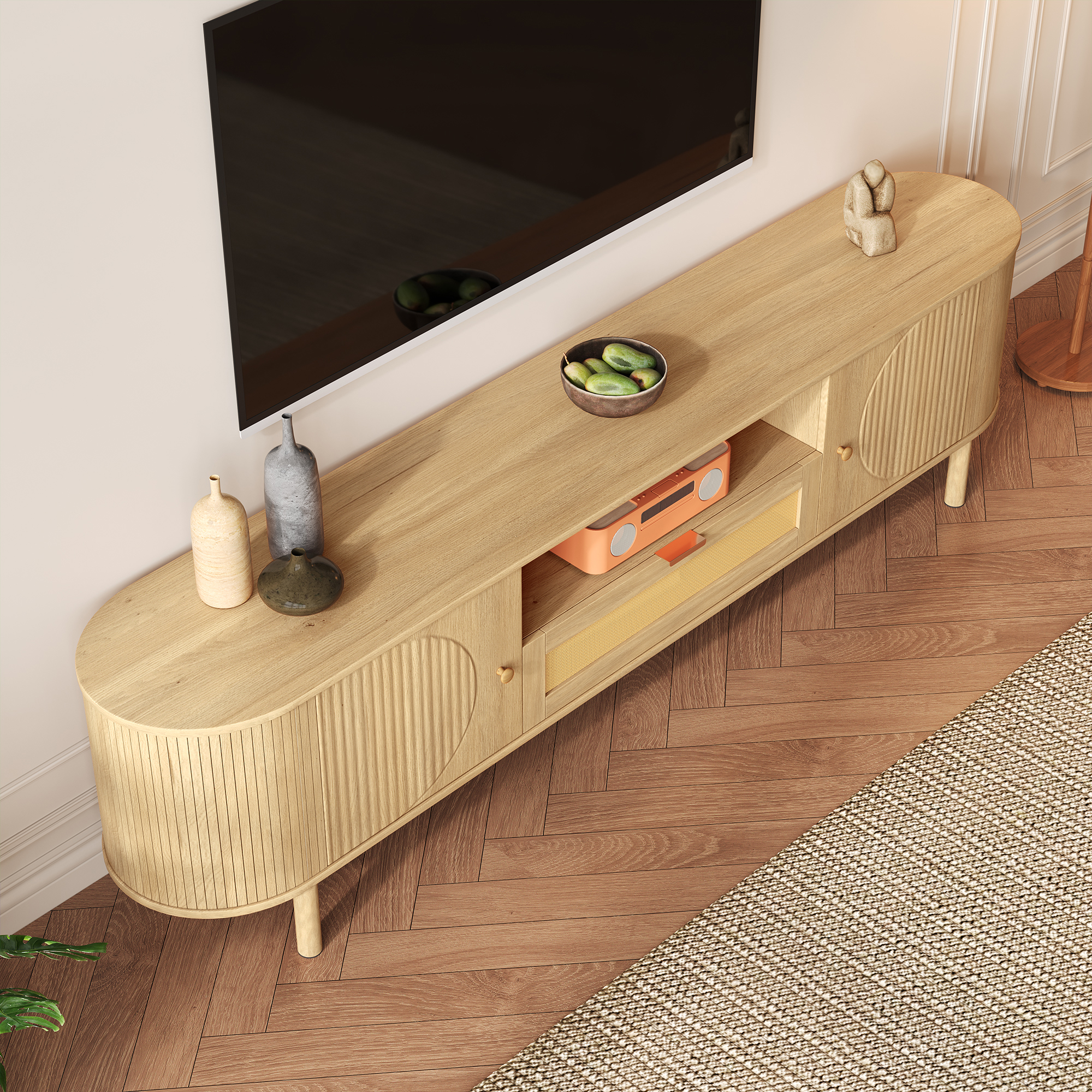 Modern TV stand with rattan drawers, open compartments, rounded tabletop, metal legs in a wood look,